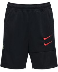 nike mini swoosh cargo shorts in black