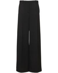 Versace Pantalon ample en sergé de laine ajourée - Noir