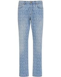 Versace - Monogram Cotton Denim Jeans - Lyst