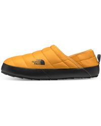 the north face thermoball traction v mule slippers in yellow