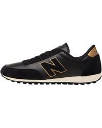 new balance black and gold trainers