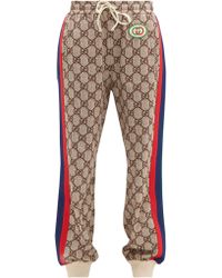 Gucci Pantalon de jogging à bandes Web et imprimé GG - Marron