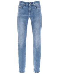 Versace - Jeans slim fit in denim elasticizzato con dettagli in metallo medusa - Lyst