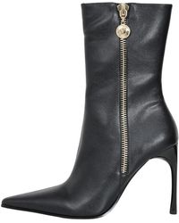 Versace - Stivali neri a punta per donne - Lyst