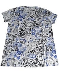 Moschino - Tops ,Veelkleurig ,Katoen Fantasia All Over Logo Wit Katoenen T-Shirt - Lyst