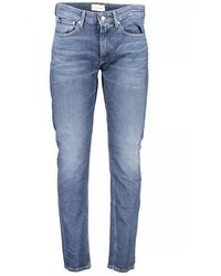 Calvin Klein - Jeans slim taper blu con effetto sbiadito - Lyst
