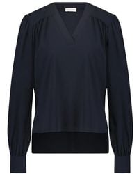 Jane Lushka - Elegante bluse aus technischem jersey | blau mit verspieltem muster - Lyst