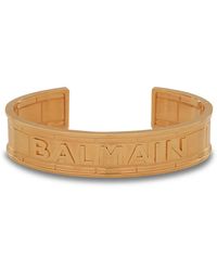 Balmain - Goldfarbener Armreif aus Messing mit -Logo - Lyst