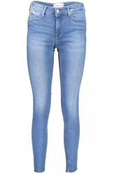 Calvin Klein - Jeans skinny fit blu chiaro con dettaglio logo - Lyst
