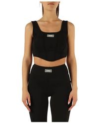 Guess - Active: top sportivo in tessuto stretch con patch logo - Lyst