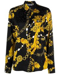 Versace - Blusa con catena floreale nera e dorata - Lyst