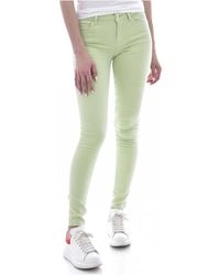 Guess - Grüne skinny jeans mit metall-logo - Lyst