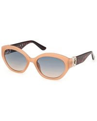 Guess - Klassische ovale sonnenbrille mit strass-logo - Lyst