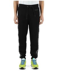 Moschino - Pantalone sportivo in cotone garzato con bande laterali logate - Lyst