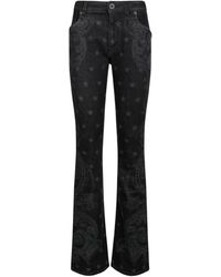 Balmain - Jeans in denim nero con stampa star e paisley - Lyst
