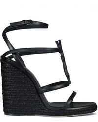 Damen Schuhe Absätze Sandalen mit Keilabsatz Saint Laurent Leder Wedge-Sandalen mit Knotendetail in Schwarz Sparen Sie 1% 