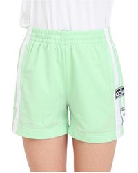 adidas Originals - Grüne und weiße shorts mit seitlichen knöpfen - Lyst