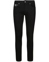 Versace - Schwarze skinnny narrow dundee jeans - Lyst