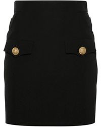 Balmain - Falda negra de crepé de lana con botones de cabeza de león - Lyst