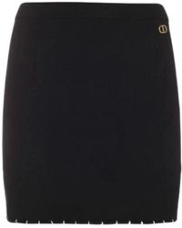 Twin Set - Falda mini negra de punto con detalle t dorado - Lyst