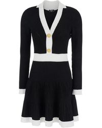 Balmain - Kleedjes ,Zwart ,Polyester Zwarte V-Hals Gebreide Flare Jurk - Lyst