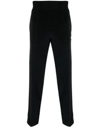 Moncler - Pantaloni neri con dettagli a strisce laterali - Lyst