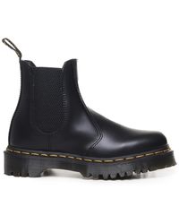 Dr. Martens - Stivali in pelle nera con cuciture gialle - Lyst