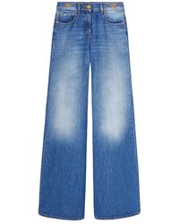 Versace - Jeans in denim blu indaco con logo oro - Lyst
