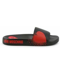 Femme Chaussures plates Chaussures plates Love Moschino Sandalo Love Moschino en coloris Noir 