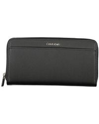 Calvin Klein - Accessoires ,Zwart ,Polyester Elegante Zwarte Rfid Veilige Portemonnee - Lyst