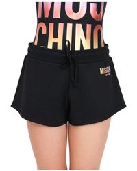 Moschino - Shorts neri con stampa logo per donna - Lyst