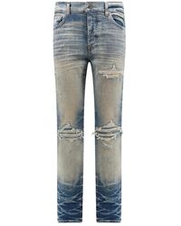 Amiri - Jeans in cotone elasticizzato con effetto strappato - Lyst