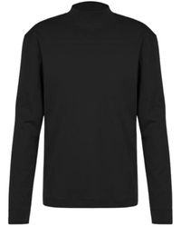 DRYKORN - Magliette nera a maniche lunghe con colletto alto - Lyst