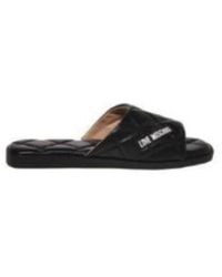 Love Moschino - Gesteppter Schwarzer Slipper Mit Logo-Print - Lyst