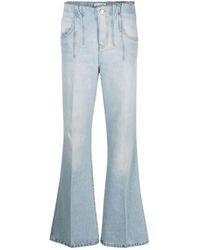 Victoria Beckham - Zerrissene flared jeans in hellblau - Lyst