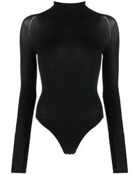 Alaïa - Top in jersey elasticizzato nero con collo alto e maniche lunghe - Lyst