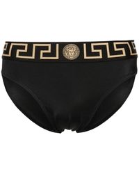 Versace - Schwarze und goldene badebekleidung - Lyst