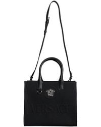 Versace - Schwarze Canvas-Leder-Crossbody-Tasche - Lyst