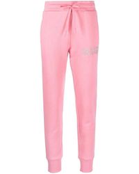 Versace - Pantaloni fitness rosa con logo ricamato - Lyst