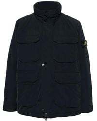 Stone Island - Jassen ,Blauw ,Polyester Blauw Gewatteerd Jack Hoge Kraag - Lyst