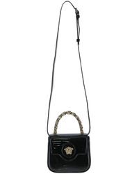 Versace - Schwarze mini tasche aus lackleder - Lyst