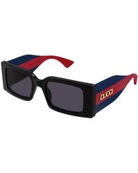 Gucci - Stylische sonnenbrille mit rot-blauen bügeln - Lyst