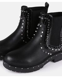 black sole stitch chelsea boots