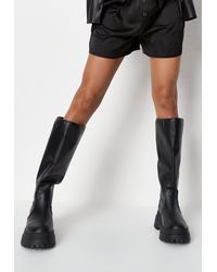 black sole stitch chelsea boots