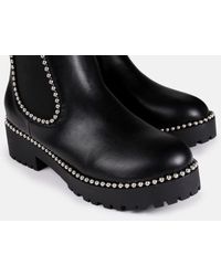 black sole stitch chelsea boots