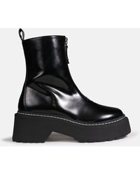 black sole stitch chelsea boots