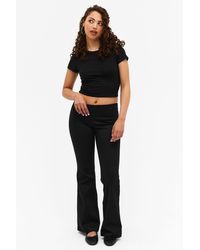 Monki - Low Waist Tight Fit Flared Stretchy Trousers - Lyst