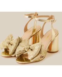 Monsoon - Women's Gold Metallic Bow Block Heel Sandals, Size: 37 - Lyst