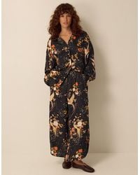 Monsoon - Clemence Seraphine Floral Print Satin Wide Leg Trousers Black - Lyst