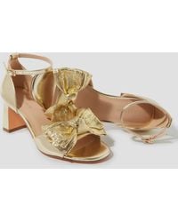 Monsoon - Taya Metallic Bow Heeled Sandals Gold - Lyst